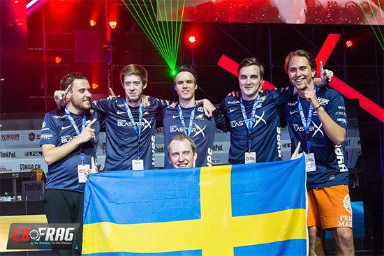 Esport winner sweden team celebrating on the stage with the swedish flag.