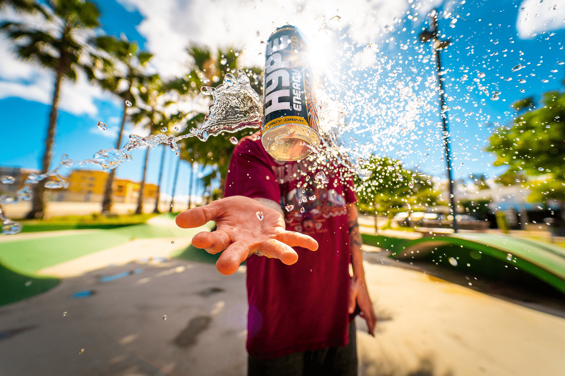 A skater throw up to the air an energy drinks can.