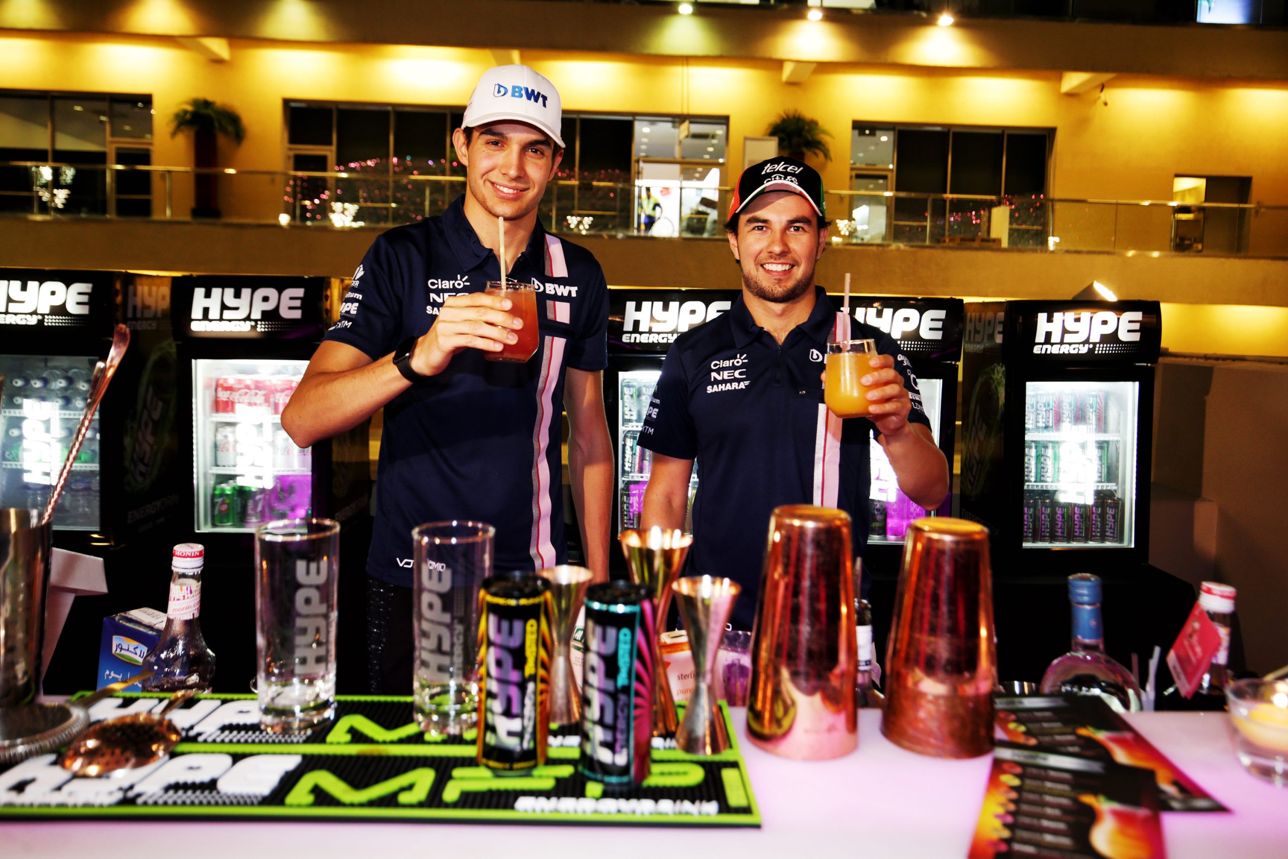 Sergio Perez and Esteban Ocon drink cocktails.
