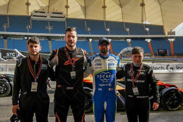 Car racing team posing on the track
