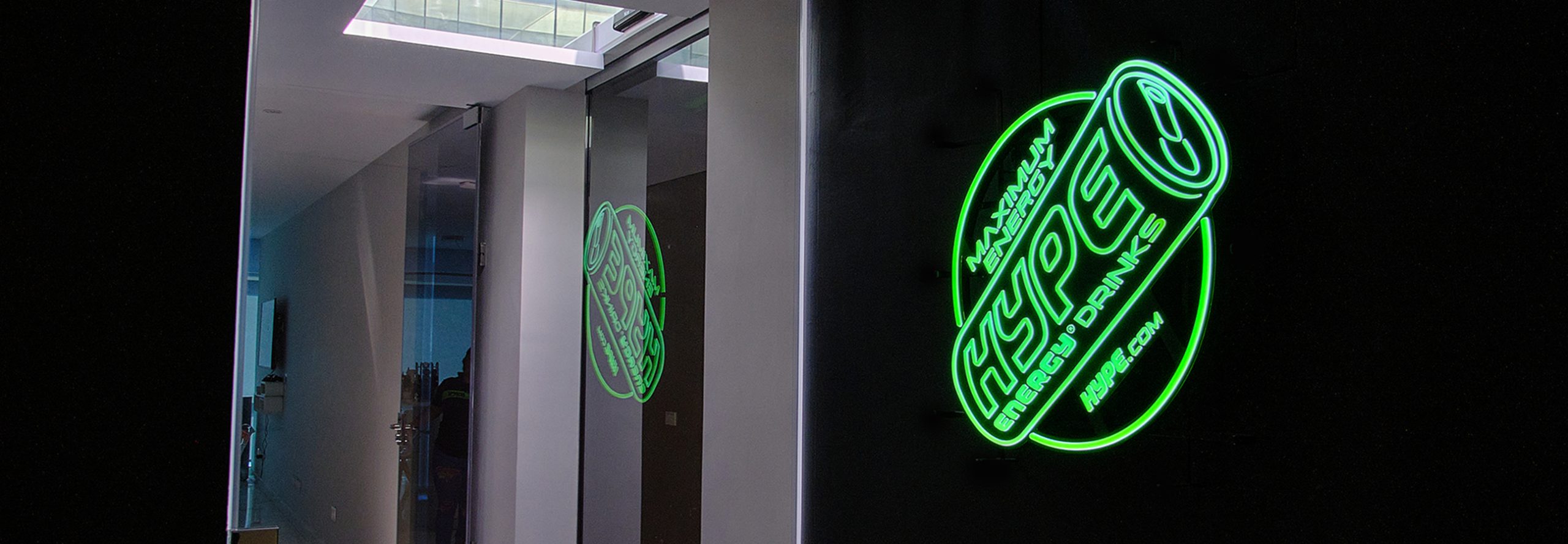 Lighting Hype Energy Drink logo in green on the black wall.